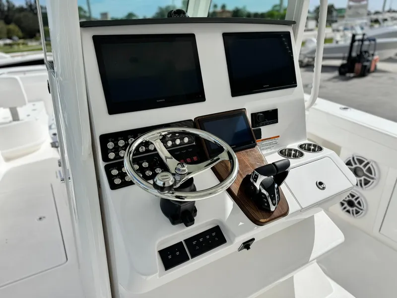 Slide: The Image of 2025 Caymas 30 CT boat dashboard with dual screens and modern controls. - 12