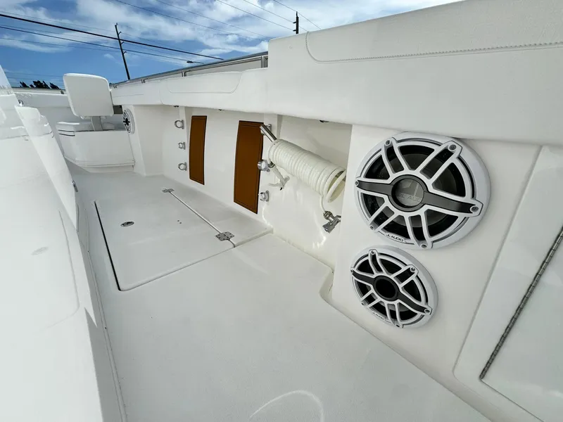 Slide: The Image of 2025 Caymas 30 CT boat deck with speakers and storage compartments. - 17