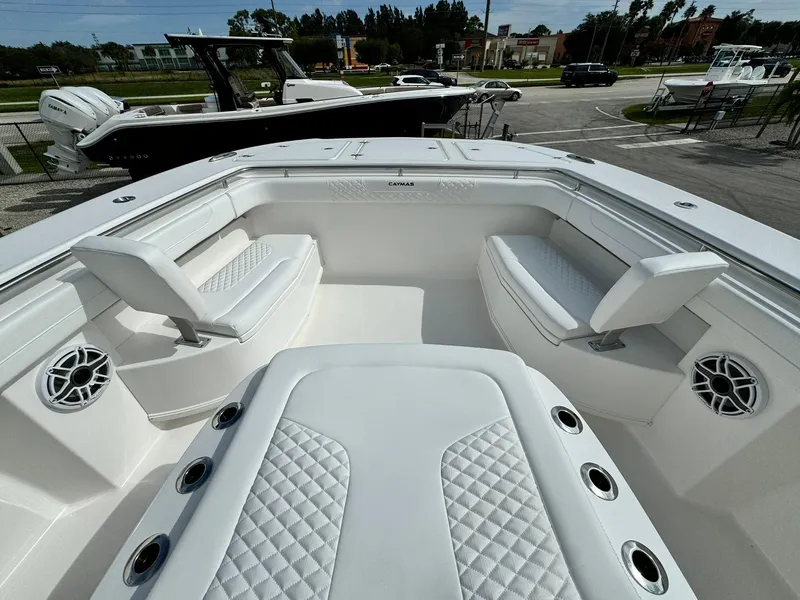 Slide: The Image of 2025 Caymas 30 CT boat interior with white seating and speakers. - 20