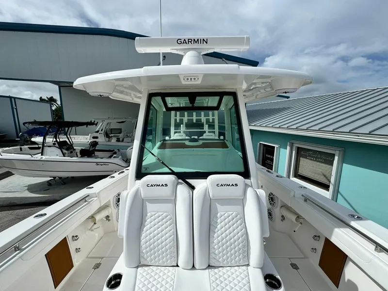 Slide: The Image of 2025 Caymas 30 CT boat with Garmin equipment, docked near blue building. - 26