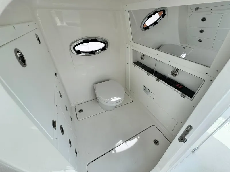 Slide: The Image of 2025 Caymas 30 CT boat interior bathroom with modern fixtures and porthole windows. - 27