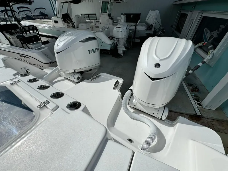 Slide: The Image of 2025 Caymas 30 CT boat with dual Yamaha outboard engines in a marina setting. - 4
