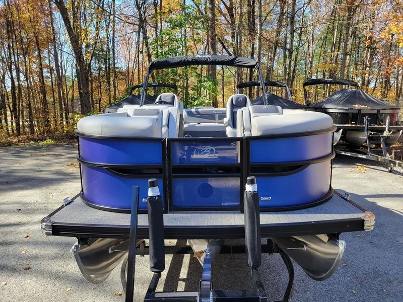 Slide: The Image of 2025 Barletta C22UC pontoon boat in a wooded area, rear view. - 12