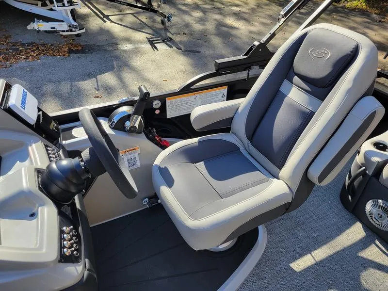 Slide: The Image of 2025 Barletta C22UC boat captain's chair and steering console in sunlight. - 17
