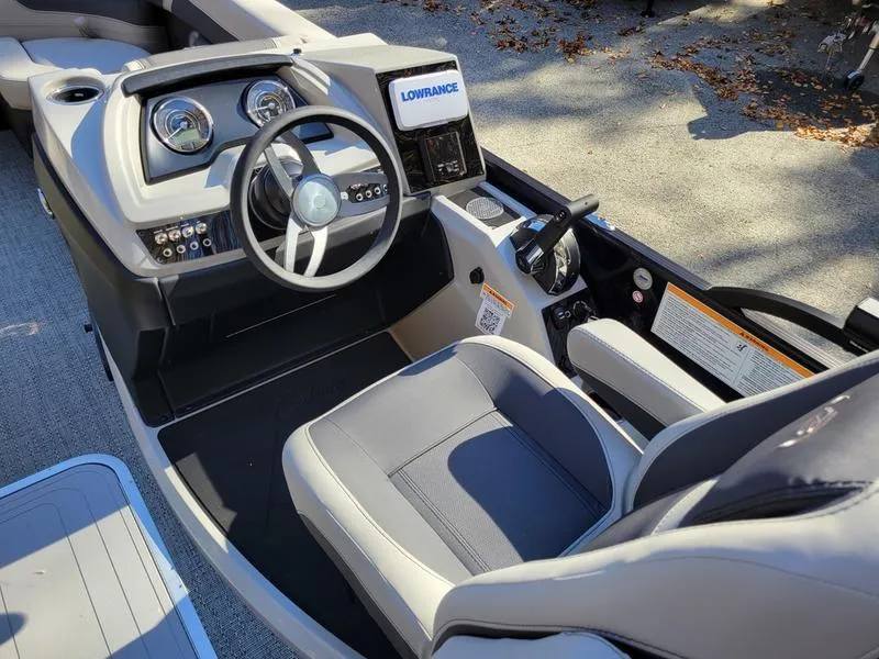 Slide: The Image of 2025 Barletta C22UC boat cockpit with steering wheel and navigation system. - 19
