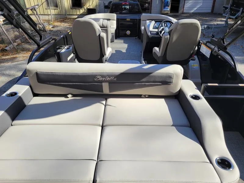 Slide: The Image of 2025 Barletta C22UC pontoon boat interior with plush seating and modern dashboard. - 25