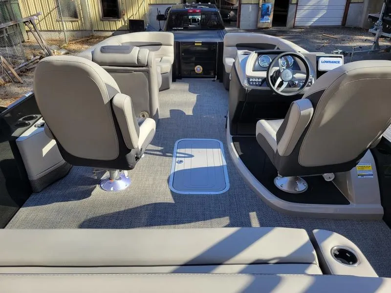 Slide: The Image of 2025 Barletta C22UC pontoon boat interior with plush seating and modern dashboard. - 26