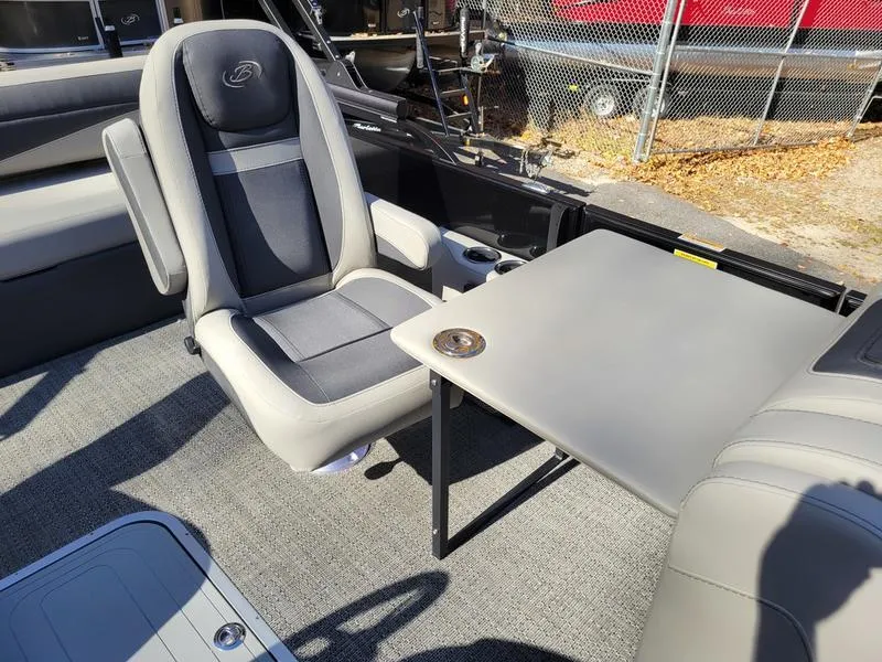 Slide: The Image of 2025 Barletta C22UC boat interior with seating and table setup. - 27