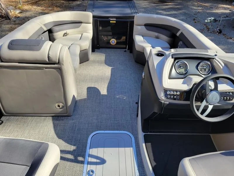 Slide: The Image of 2025 Barletta C22UC pontoon boat interior with plush seating and modern dashboard. - 28