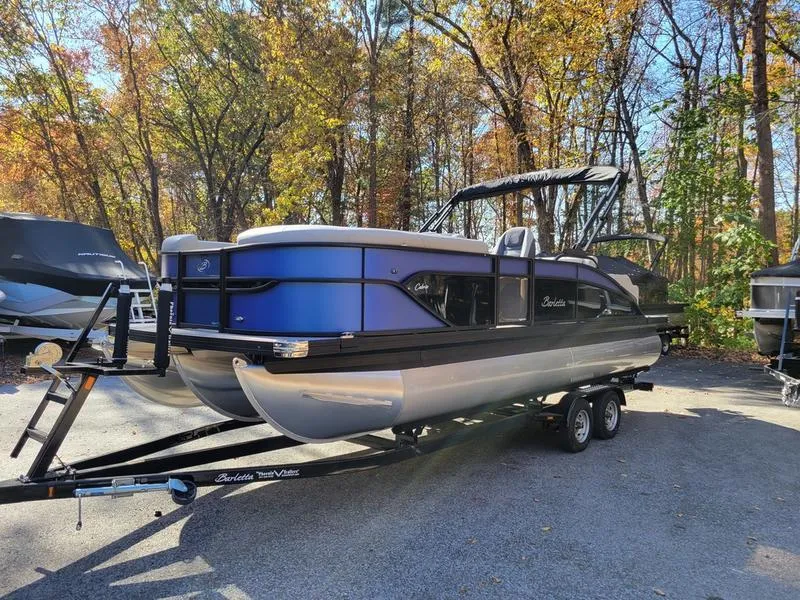 Slide: The Image of 2025 Barletta C22UC pontoon boat on trailer, surrounded by autumn trees. - 6