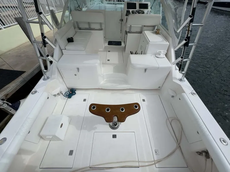 Slide: The Image of 2007 Cabo 35 Express boat deck with seating and fishing rod holders. - 15