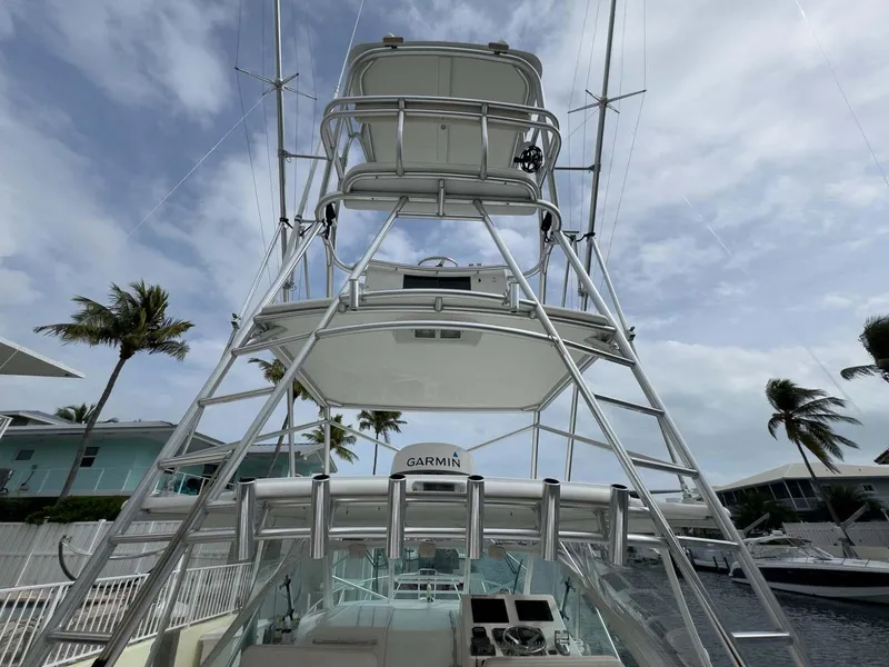 Slide: The Image of 2007 Cabo 35 Express boat with tower and Garmin equipment, docked under a cloudy sky. - 17