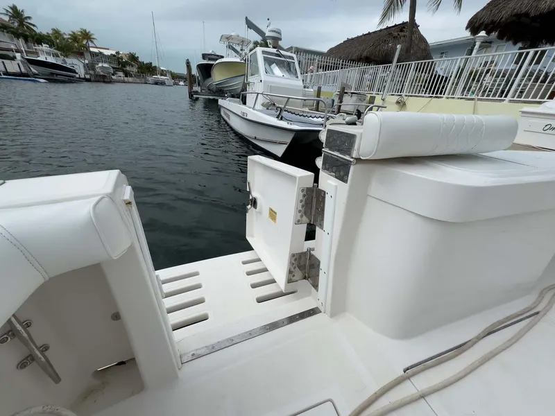Slide: The Image of 2007 Cabo 35 Express boat docked, featuring open transom door and marina view. - 20