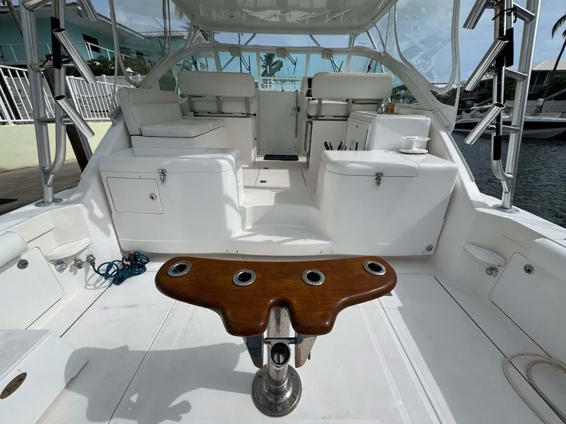 Slide: The Image of 2007 Cabo 35 Express boat interior with fishing rod holders and seating area. - 38