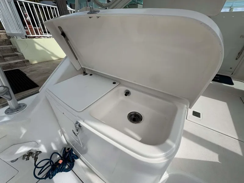 Slide: The Image of 2007 Cabo 35 Express boat sink with open lid on deck. - 40