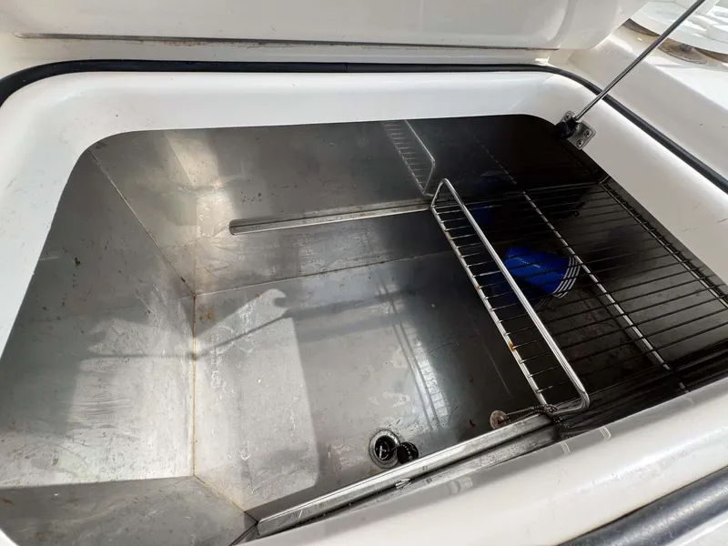 Slide: The Image of Open storage compartment on 2007 Cabo 35 Express boat with metal rack. - 42