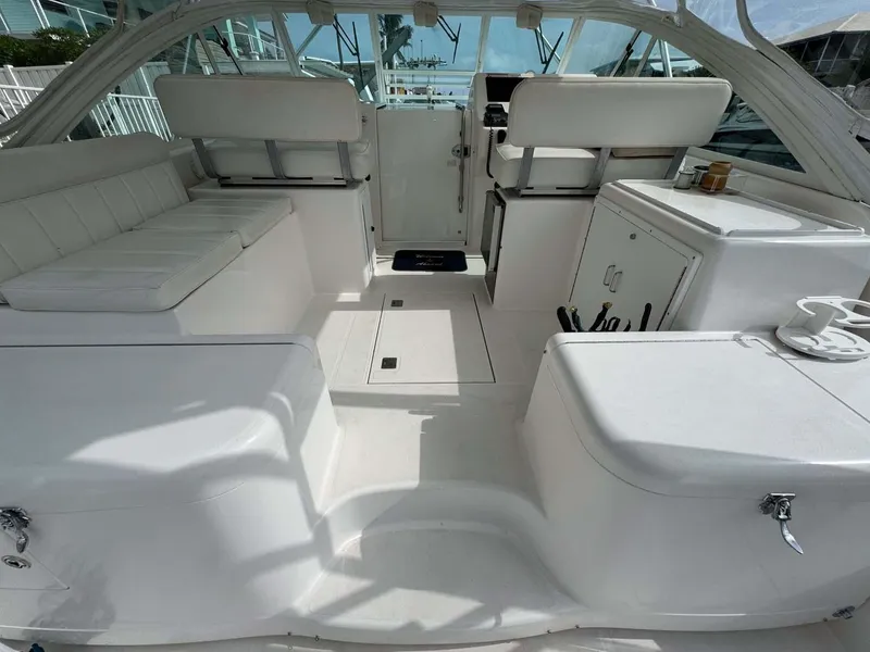 Slide: The Image of 2007 Cabo 35 Express boat interior with white seating and storage compartments. - 43