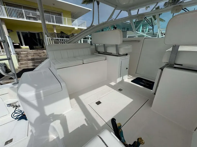 Slide: The Image of 2007 Cabo 35 Express boat interior with white seating and helm station. - 45