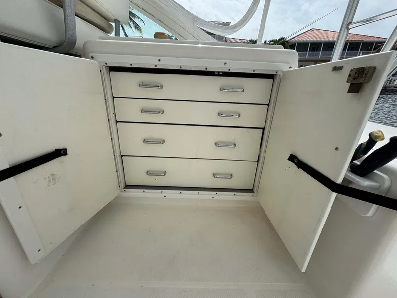 Slide: The Image of Open storage cabinet with four drawers on a 2007 Cabo 35 Express boat. - 47