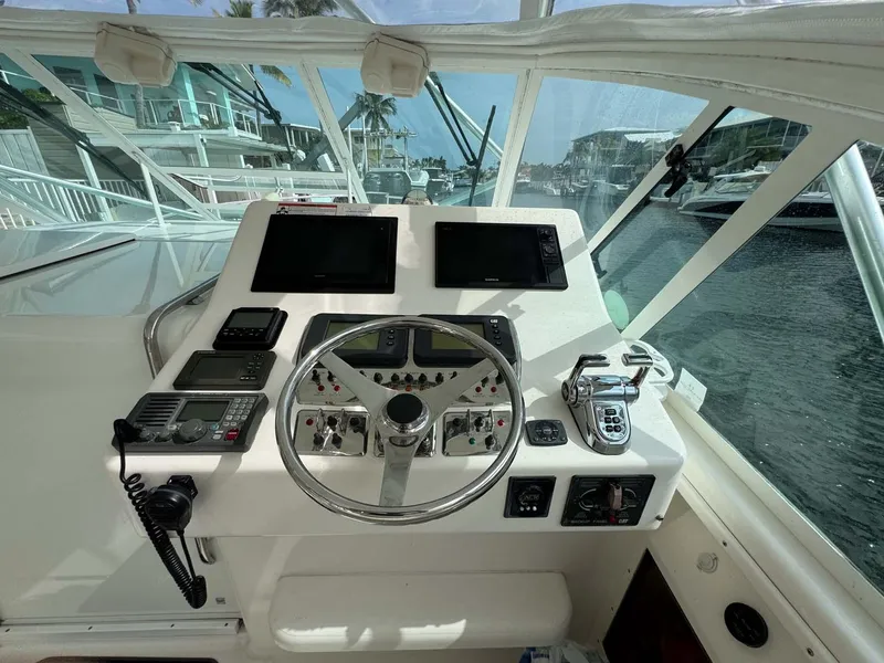 Slide: The Image of 2007 Cabo 35 Express helm with dual screens and navigation controls. - 48