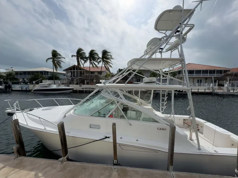 Slide: The Image of 2007 Cabo 35 Express boat docked by waterfront homes. - 6