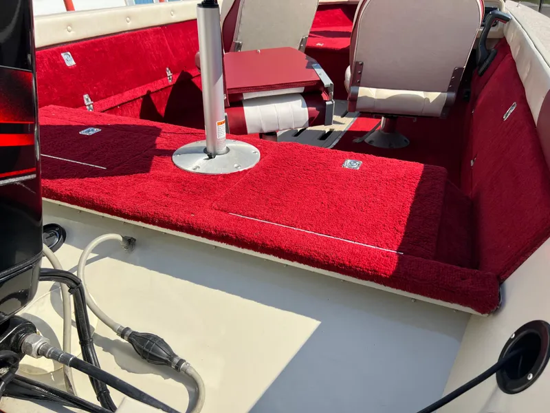 Slide: The Image of 1997 Sylvan 1600 Pro Select boat interior with red carpet and seating. - 12