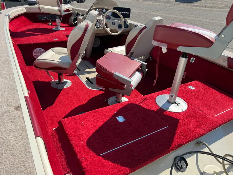 Slide: The Image of 1997 Sylvan 1600 Pro Select boat interior with red carpet and seating. - 13