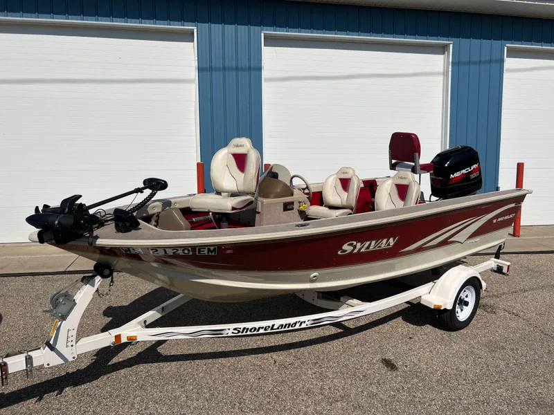 Slide: The Image of 1997 Sylvan 1600 Pro Select fishing boat on trailer, parked outdoors. - 16