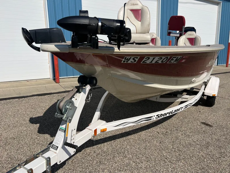 Slide: The Image of 1997 Sylvan 1600 Pro Select boat on trailer, parked outdoors. - 17