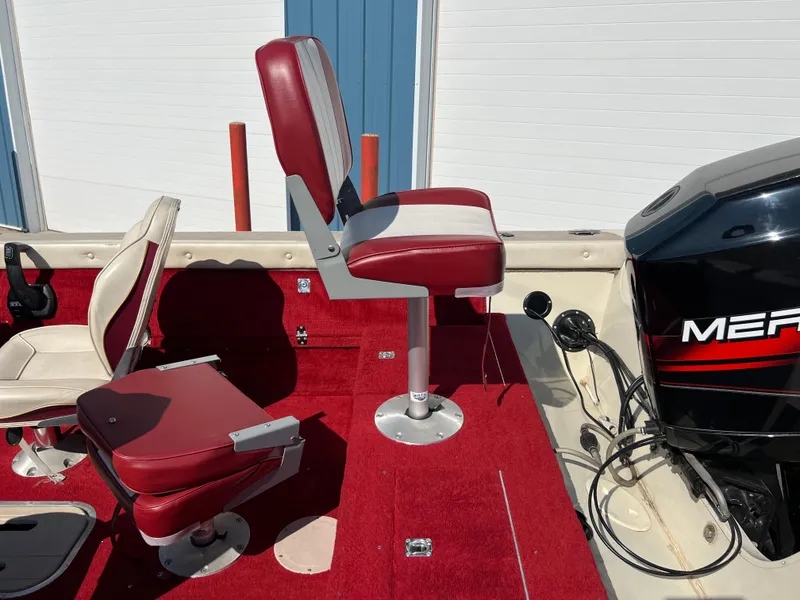 Slide: The Image of 1997 Sylvan 1600 Pro Select boat interior with red seats and Mercury engine. - 21
