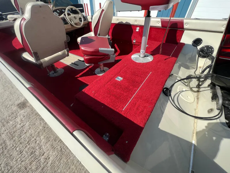 Slide: The Image of 1997 Sylvan 1600 Pro Select boat interior with red carpet and seating. - 23