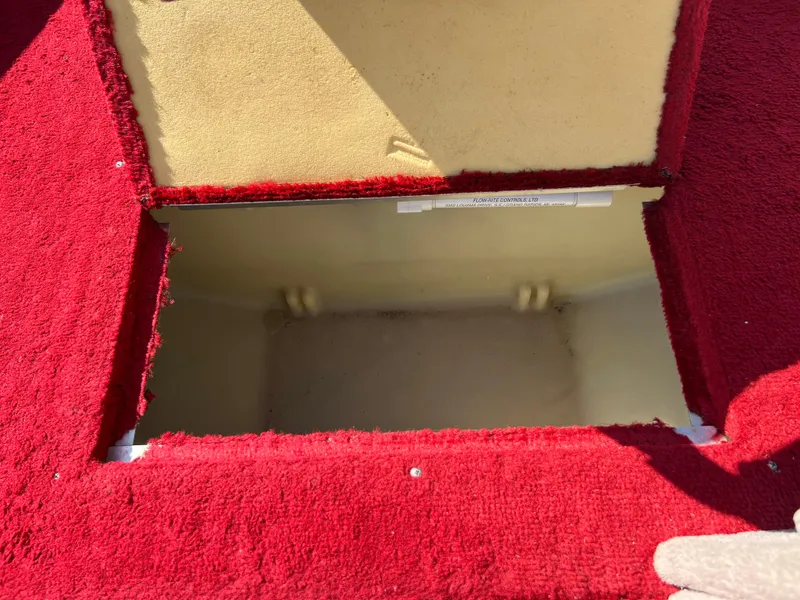 Slide: The Image of Open storage compartment in 1997 Sylvan 1600 Pro Select boat with red carpet interior. - 25