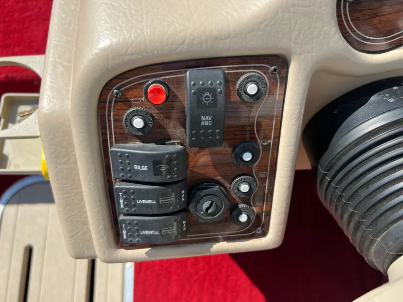 Slide: The Image of 1997 Sylvan 1600 Pro Select boat dashboard with control switches and dials. - 31