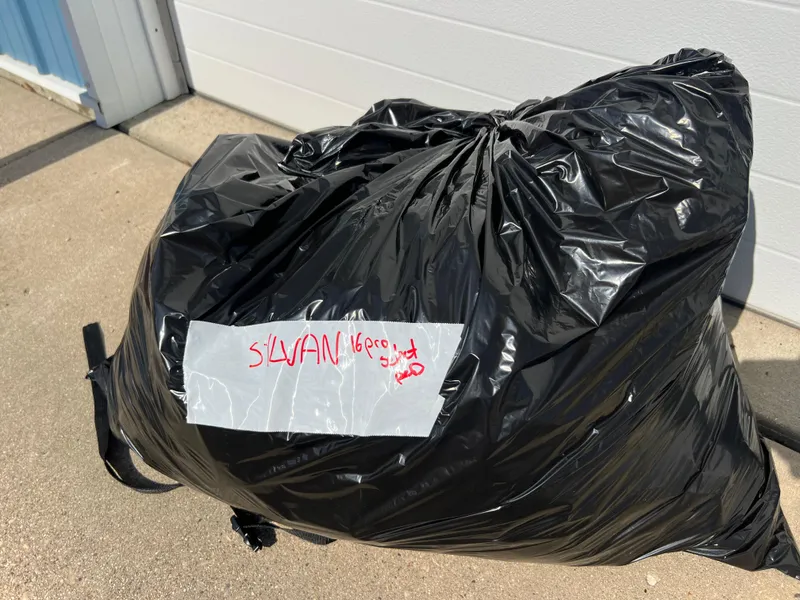 Slide: The Image of Black garbage bag labeled "Sylvan 1600 Pro Select 1997" on concrete surface. - 35