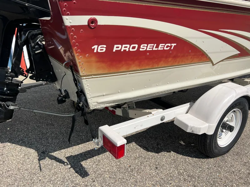 Slide: The Image of 1997 Sylvan 1600 Pro Select boat on trailer, red and white design. - 9