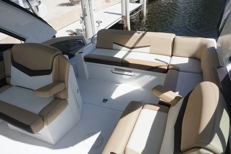 Slide: The Image of 2015 Cruisers Yachts 328 BR interior with beige seating and water view. - 11