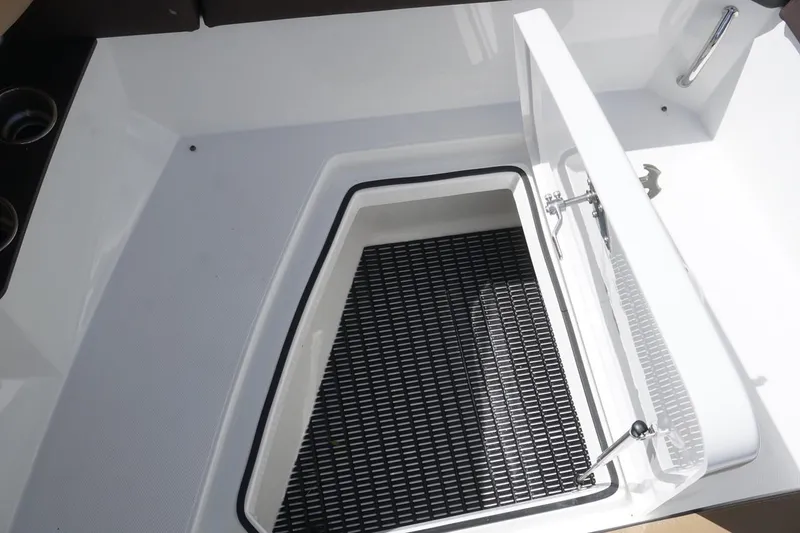 Slide: The Image of 2015 Cruisers Yachts 328 BR storage compartment with open hatch and black mat. - 4