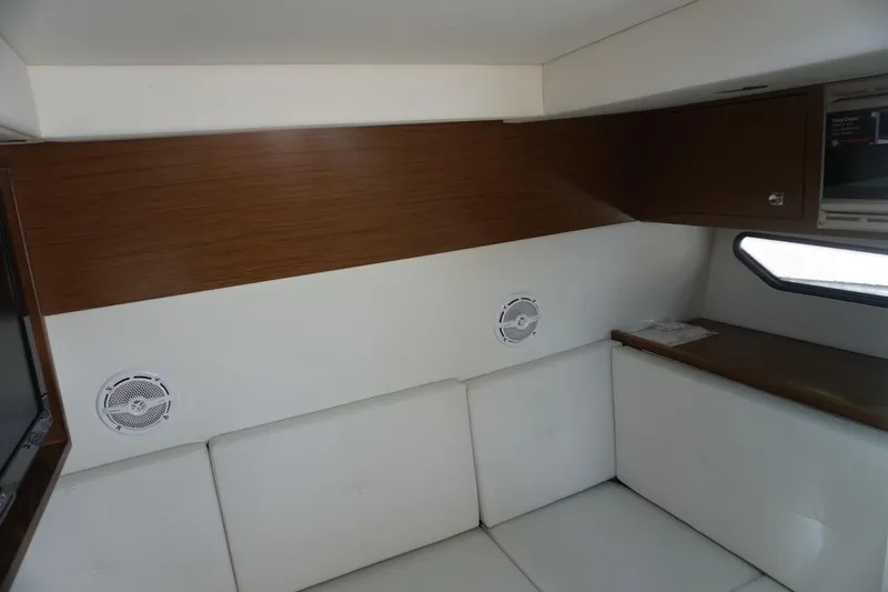 Slide: The Image of 2015 Cruisers Yachts 328 BR interior with white seating and wood accents. - 7