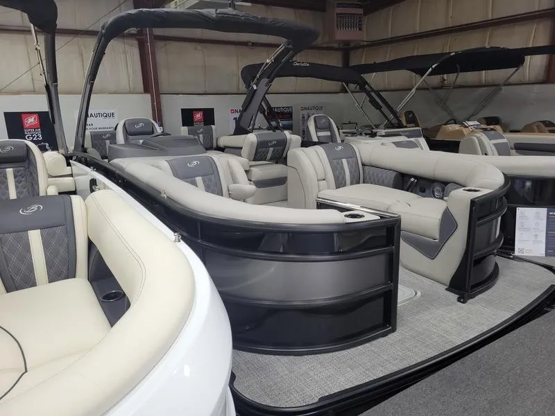 Slide: The Image of 2025 Barletta L23MA pontoon boat with luxurious seating in a showroom. - 10