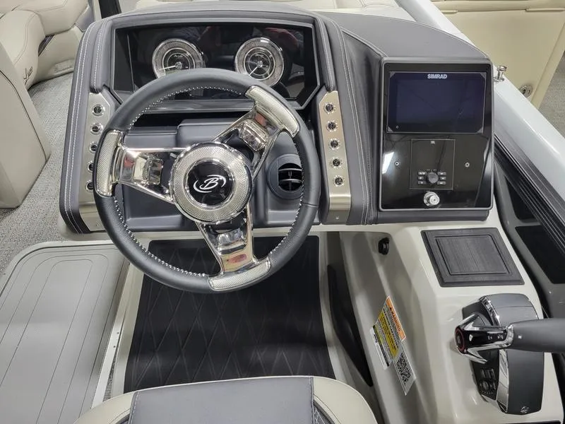 Slide: The Image of 2025 Barletta L23MA boat dashboard with steering wheel and control panel. - 11