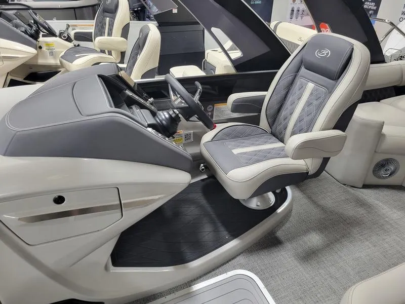 Slide: The Image of 2025 Barletta L23MA boat interior with luxury captain's chair and steering console. - 24