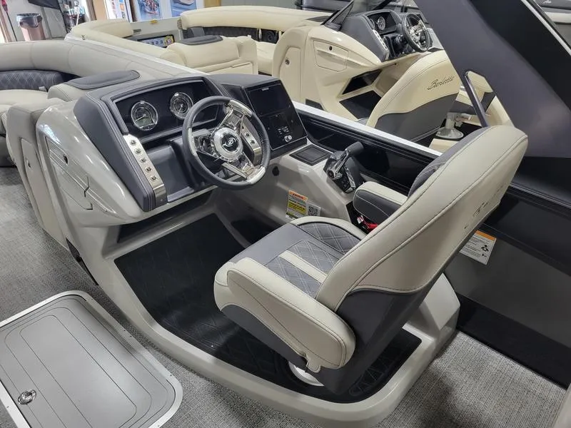 Slide: The Image of 2025 Barletta L23MA boat interior with modern steering console and luxurious seating. - 25