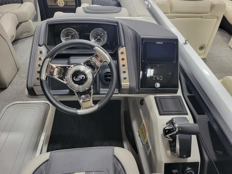 Slide: The Image of 2025 Barletta L23MA boat dashboard with steering wheel and control panel. - 26