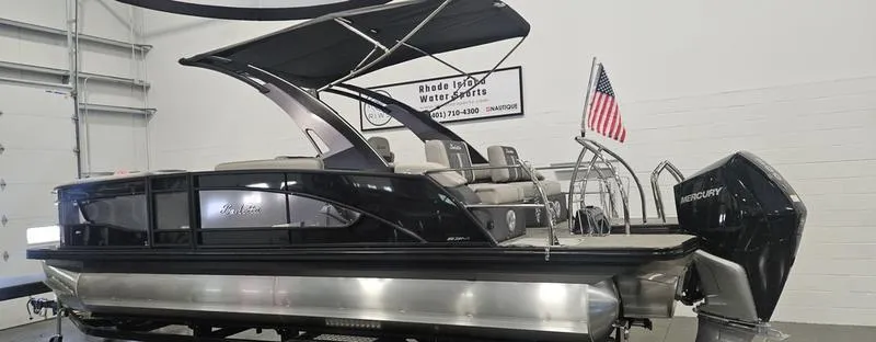 Slide: The Image of 2025 Barletta L23MA pontoon boat with canopy and Mercury engine in showroom. - 3