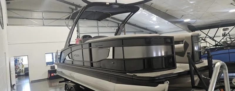 Slide: The Image of 2025 Barletta L23MA pontoon boat displayed indoors, showcasing sleek design and modern features. - 4