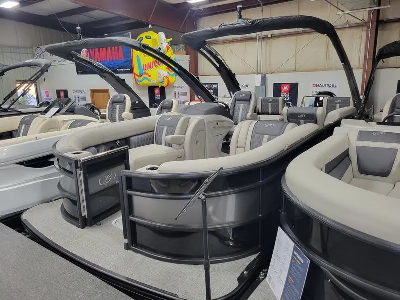 Slide: The Image of 2025 Barletta L23MA pontoon boat with luxurious seating in a showroom. - 6