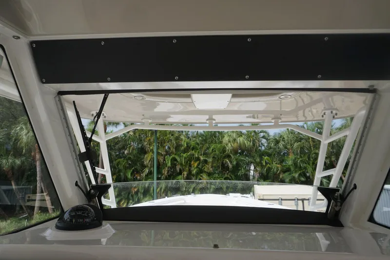 Slide: The Image of Interior view of 2017 Everglades 355 CCX boat with lush greenery outside. - 13