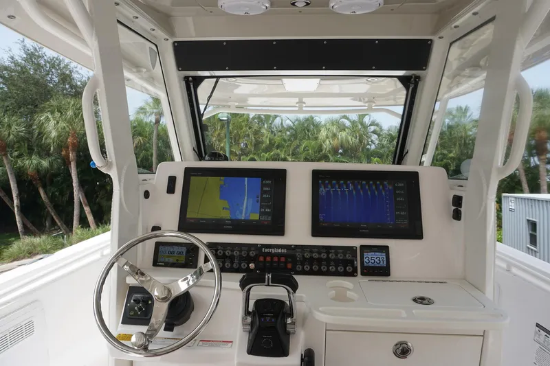 Slide: The Image of 2017 Everglades 355 CCX boat dashboard with navigation screens and steering wheel. - 14