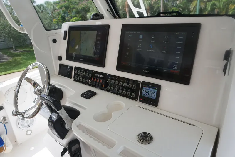 Slide: The Image of 2017 Everglades 355 CCX boat dashboard with dual screens and steering wheel. - 15