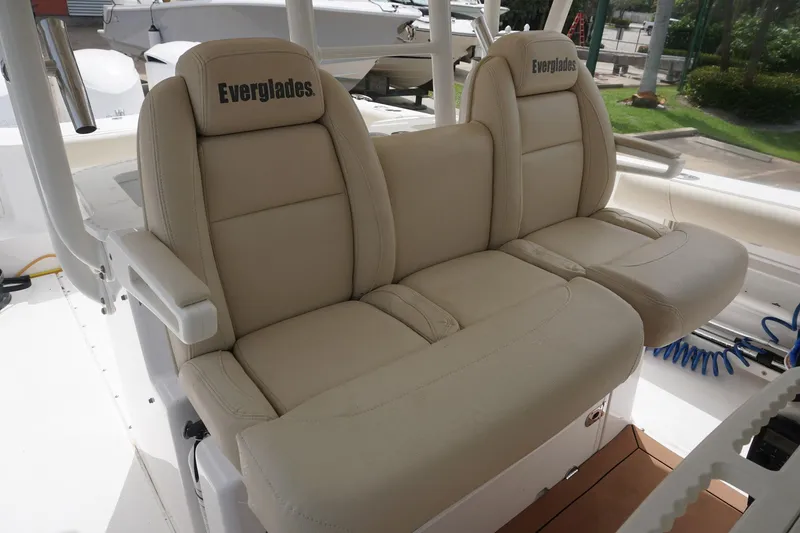Slide: The Image of 2017 Everglades 355 CCX boat seats, beige leather, outdoor setting. - 17